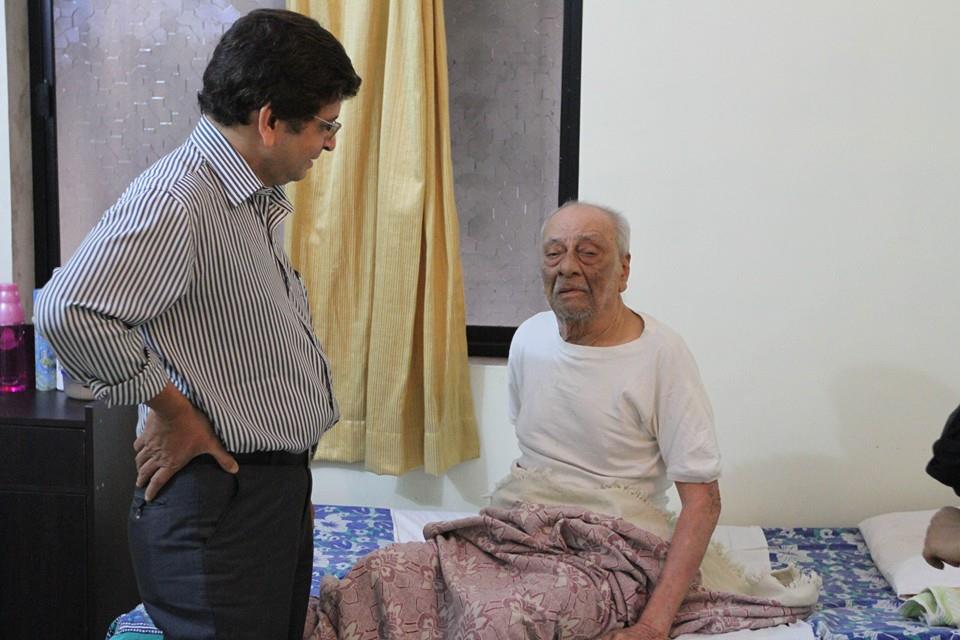 Dr. Sarosh Lambate visiting with an elderly resident at home